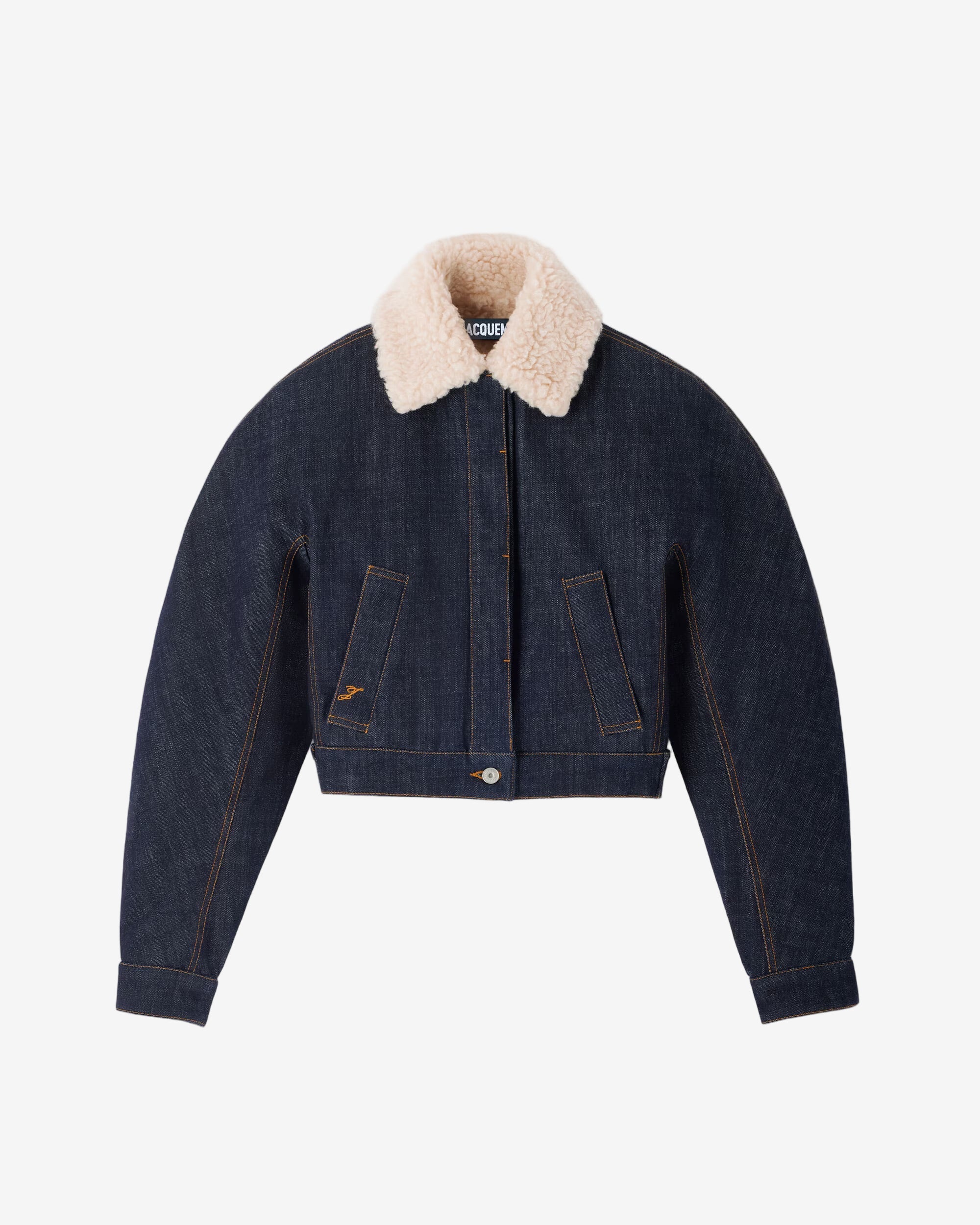 Denim jacket with beige fur collar on a light gray background