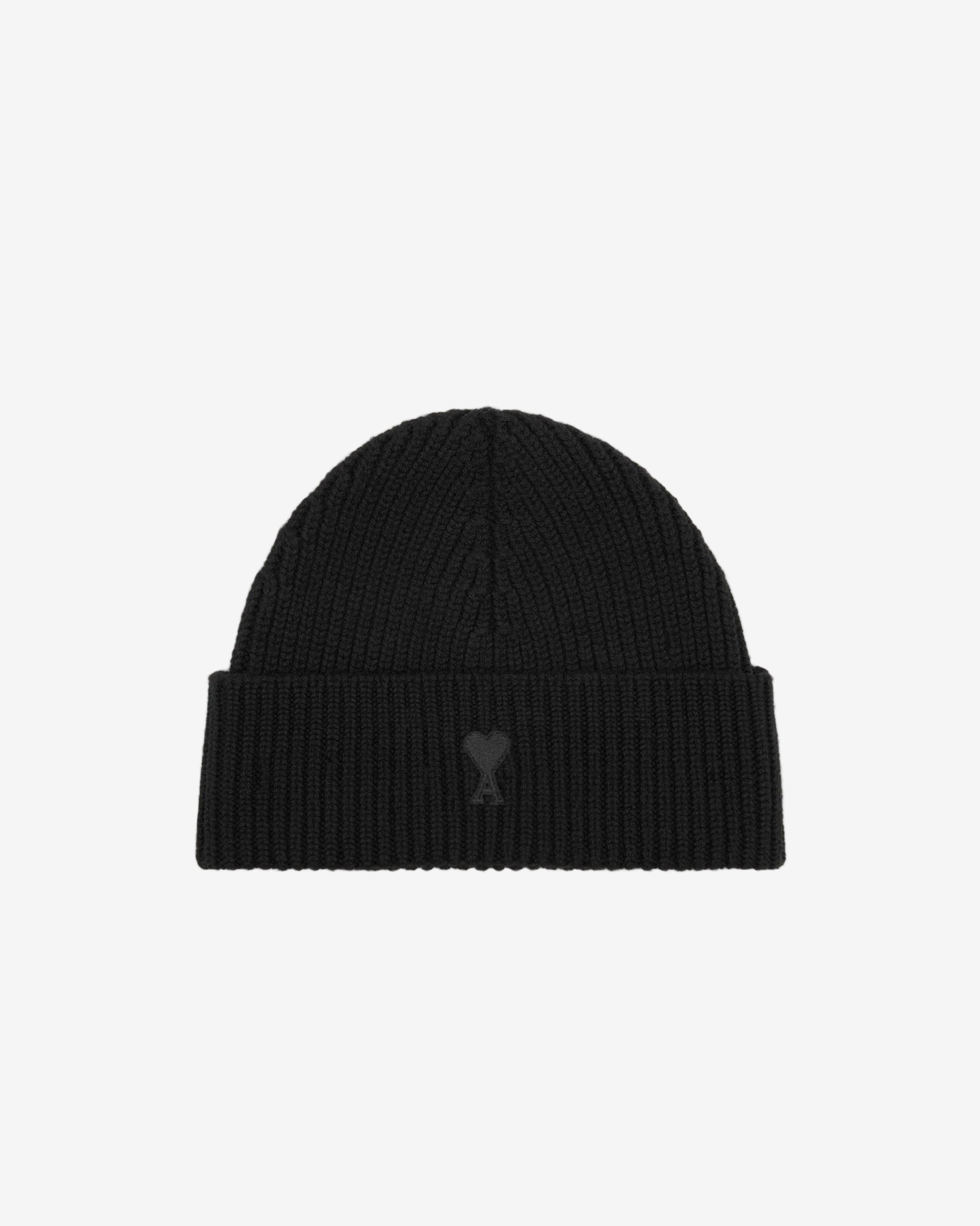 Black beanie hat on a light beige background