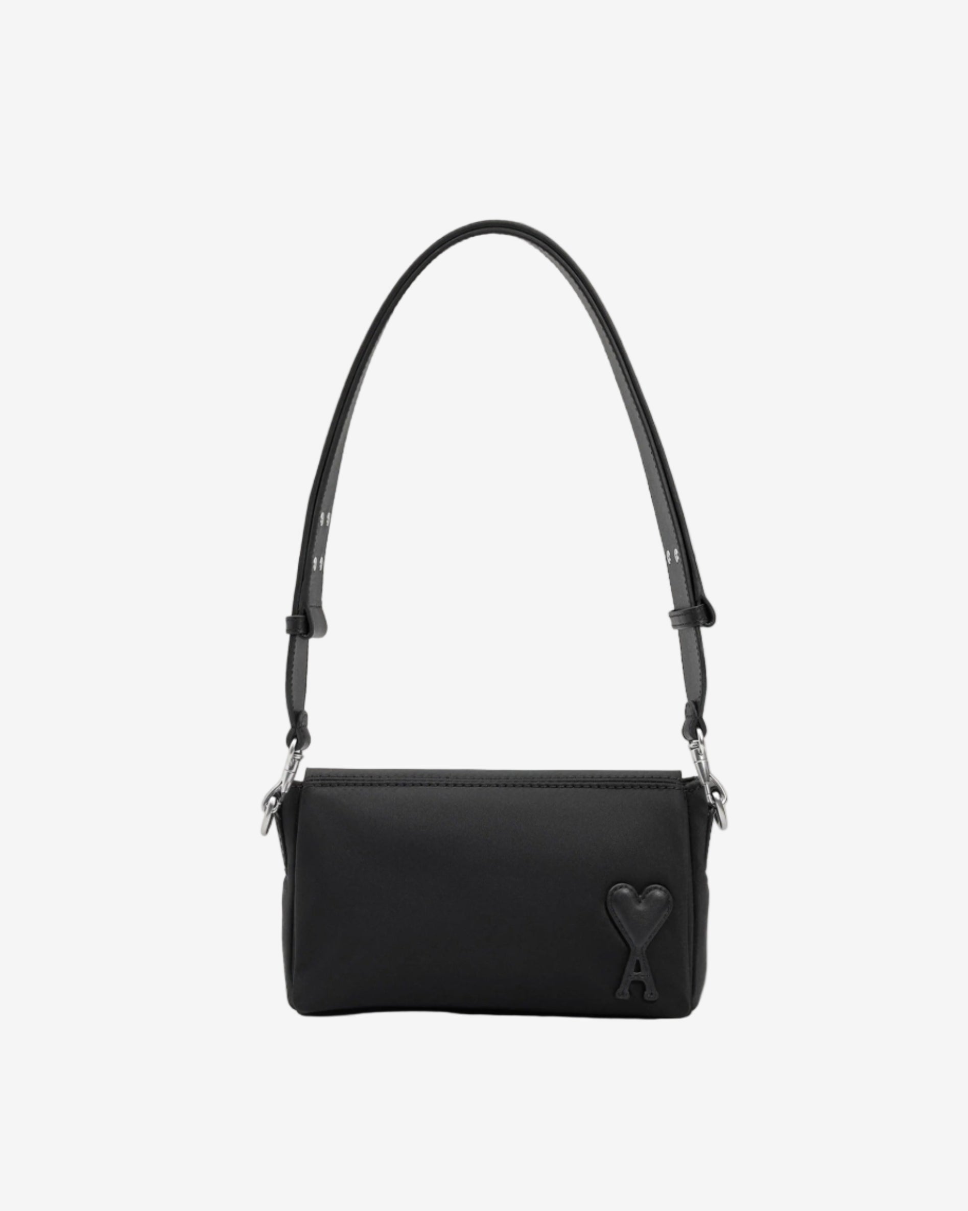 Black handbag with a strap on a light beige background