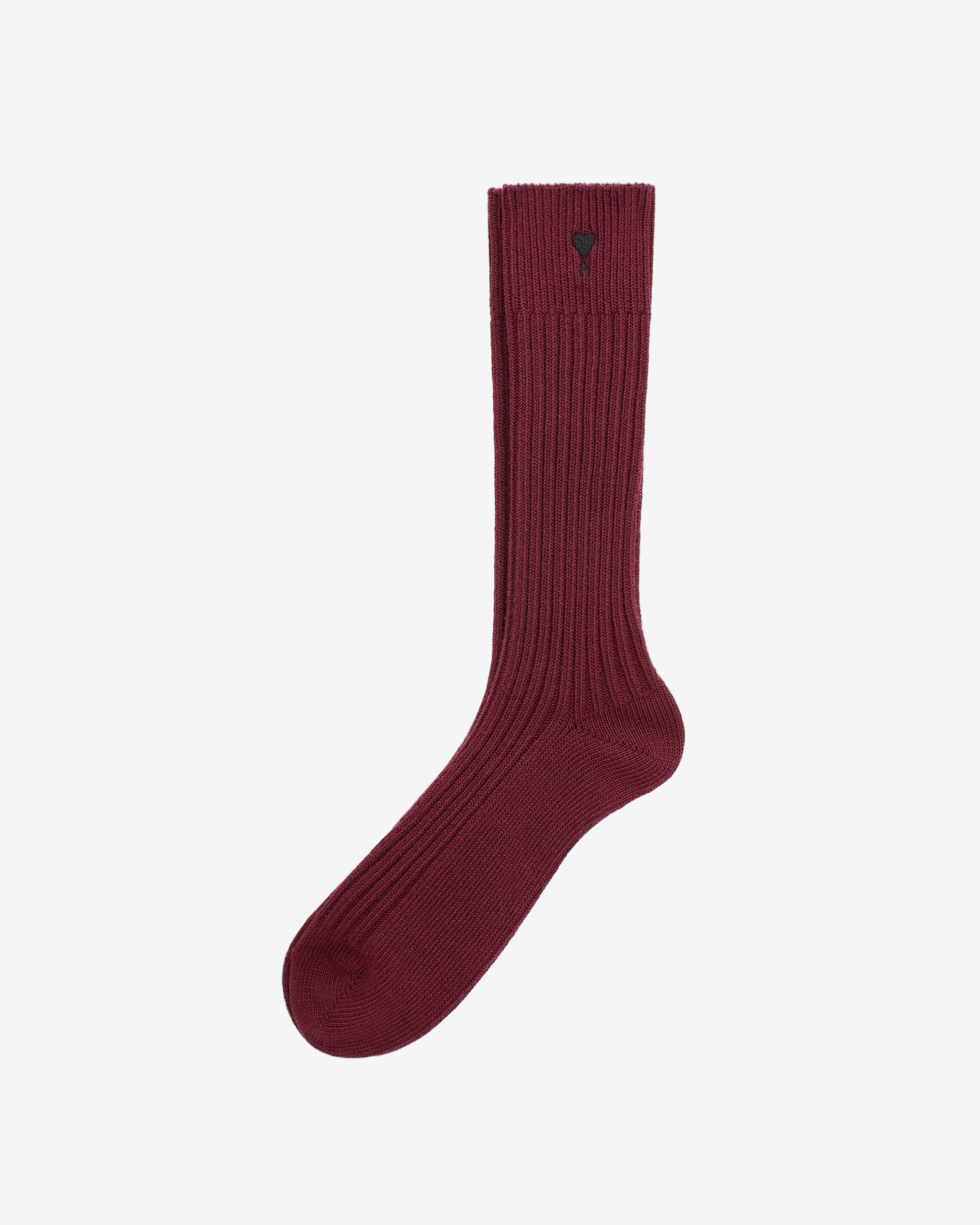 Maroon sock with a heart detail on a beige background