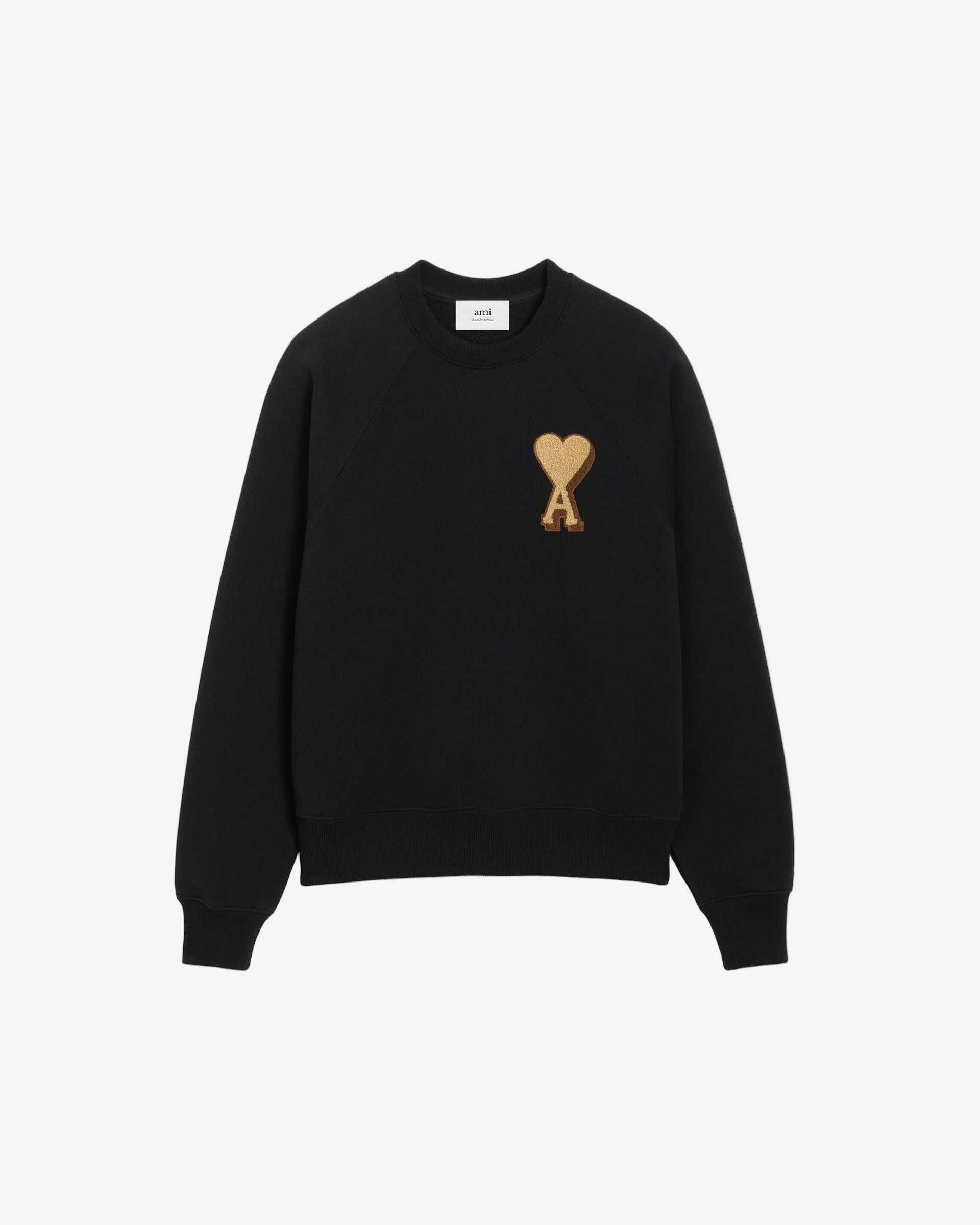 Black sweatshirt with a gold heart design on a beige background