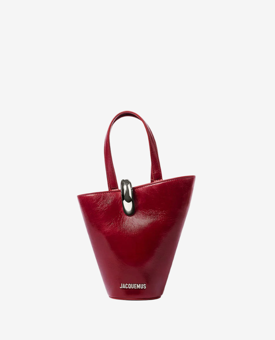 Red handbag with a gold ring on a white background