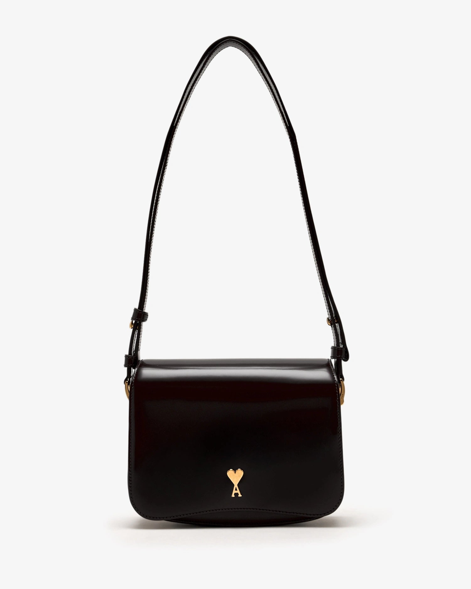 Black handbag with a gold heart emblem on a white background