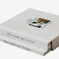Stack of books titled 'Dior/Lindbergh/New York' on a textured surface