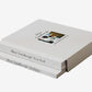 Stack of books titled 'Dior/Lindbergh/New York' on a textured surface