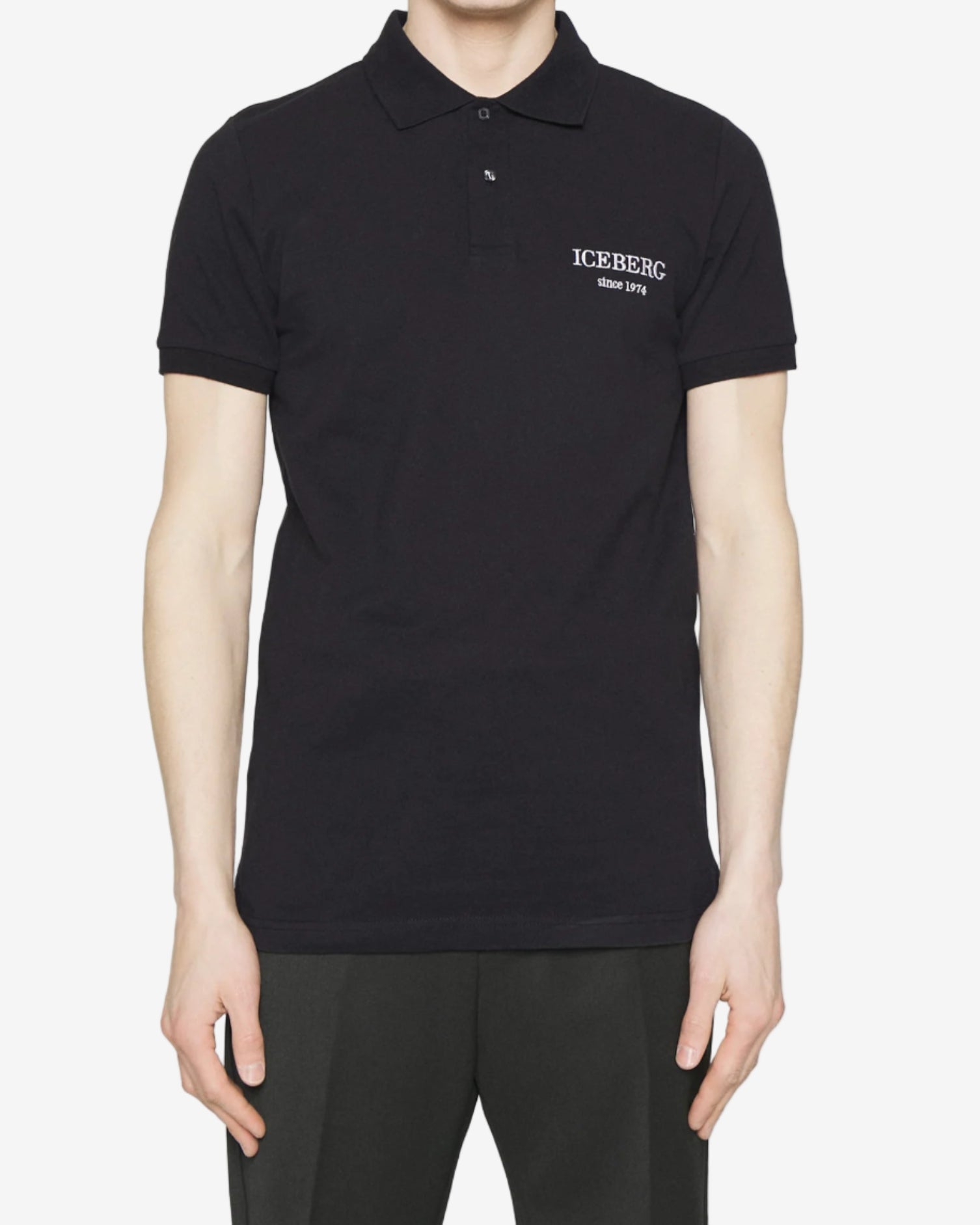 Man wearing a black polo shirt with a brand logo on a white background