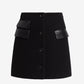 Black skirt with leather patches on a white background