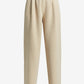 Beige pleated pants on a white background