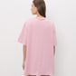 A light pink short-sleeve t-shirt with a small tonal pink ATTICO' logo on the left chest, displayed on a neutral light gray background.