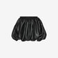 Black satin skirt on a light gray background