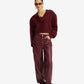 Person wearing a burgundy sweater and pants on a white background