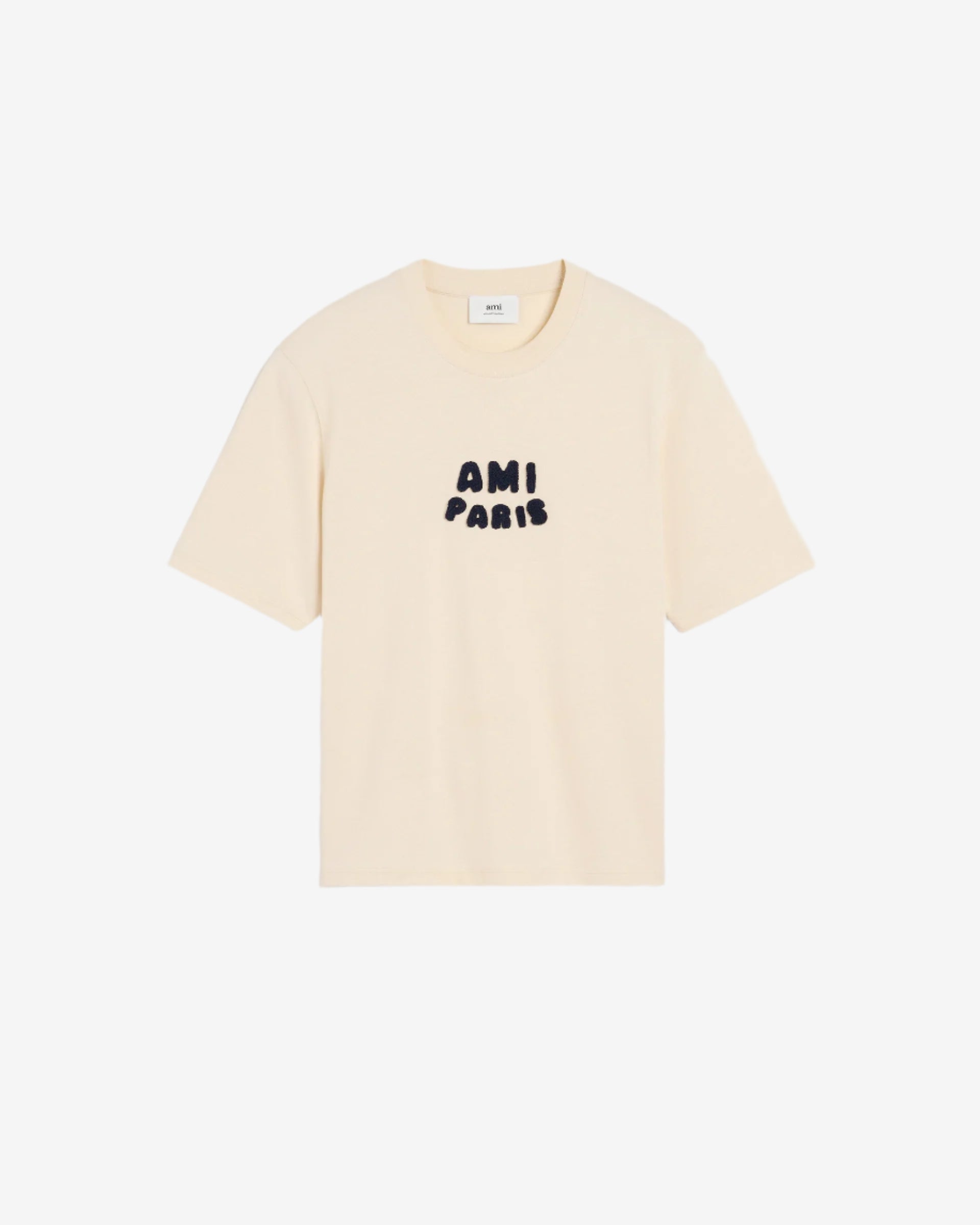 Beige t-shirt with 'AM! PARIS' text on a light gray background