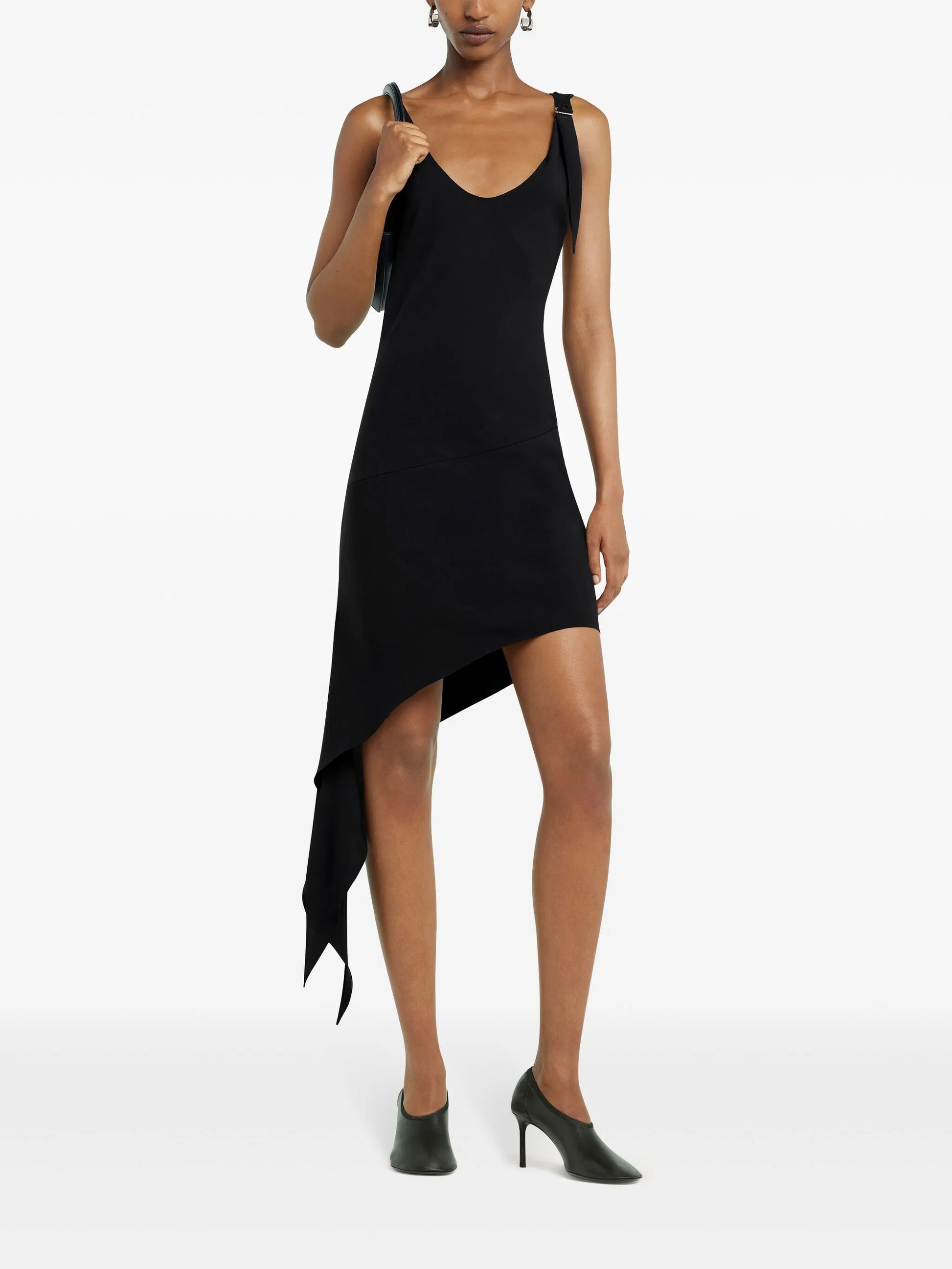 Black sleeveless dress with an asymmetrical hem on a white background