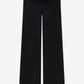 Black pants with button details on a white background