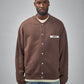 Brown jacket with a visible brand label on a white background