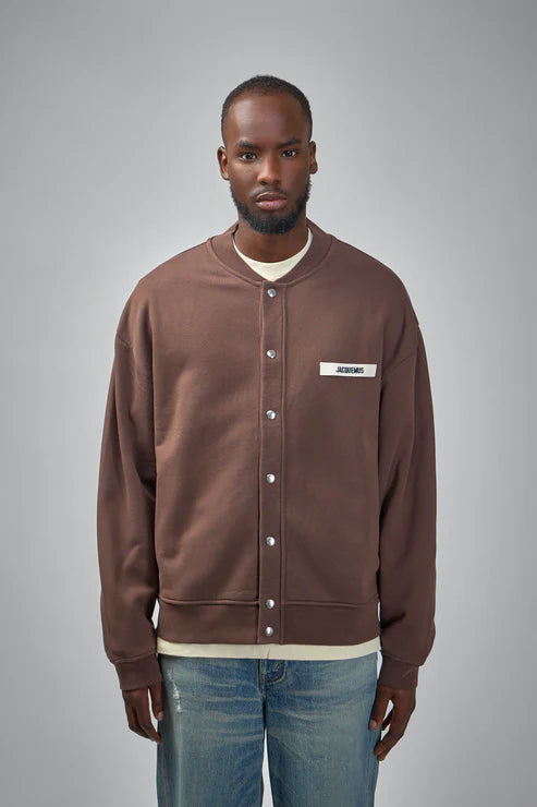 Brown jacket with a visible brand label on a white background