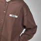 Brown jacket with a visible brand label on a white background