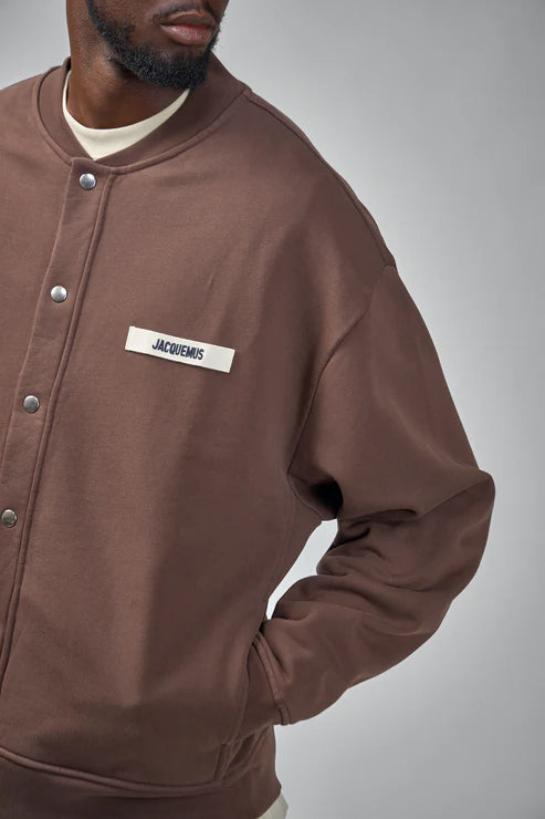 Brown jacket with a visible brand label on a white background