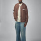Brown jacket with a visible brand label on a white background