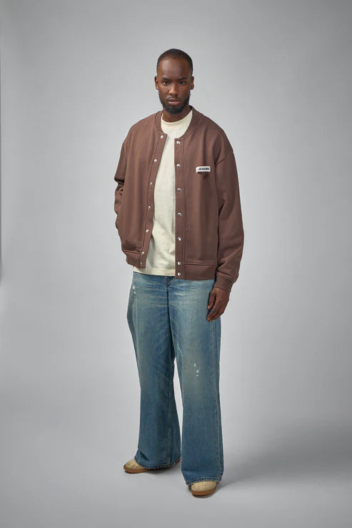 Brown jacket with a visible brand label on a white background