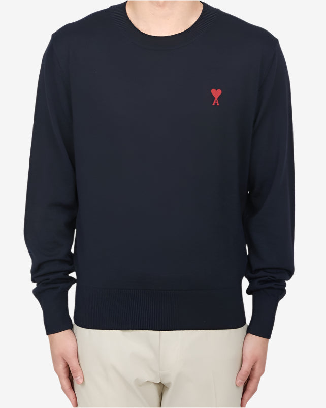 Navy blue sweater with a red heart and letter 'A' logo on a white background