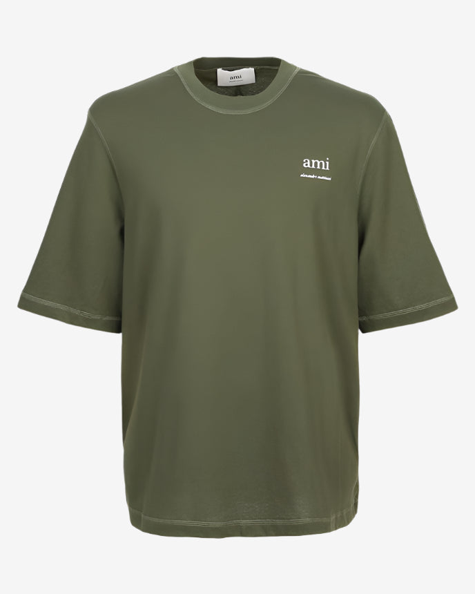 Green t-shirt with a small logo on a white background ami paris