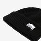 Black beanie with 'Ganni' logo on a light gray background