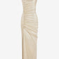 Beige evening gown with ruched design on a white background