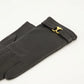 Pair of black gloves with gold logo on a white background AMI PARIS