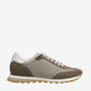 Sneaker with a beige and brown design on a light beige background