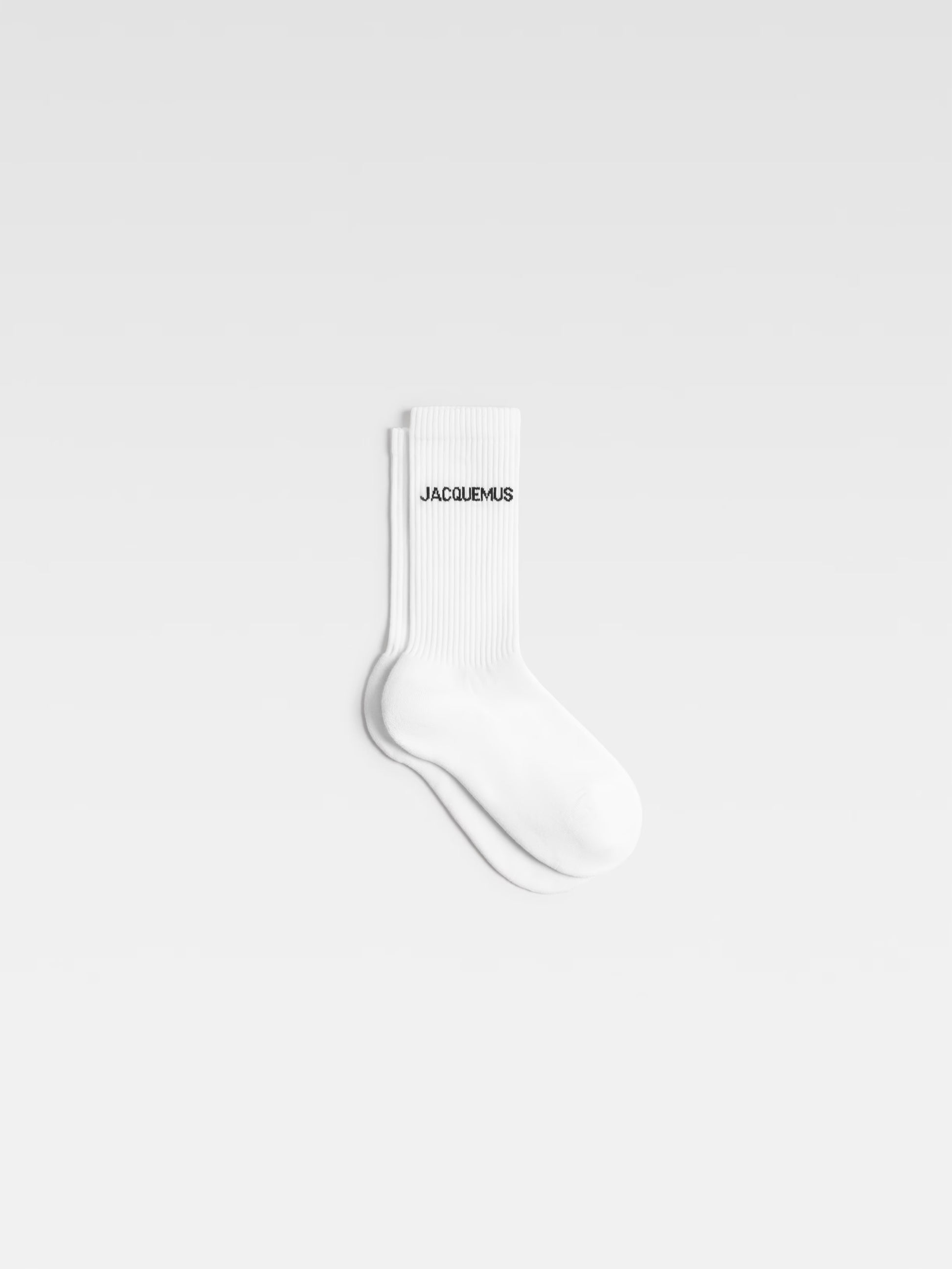 White sock with 'JACQUEMUS' branding on a light gray background