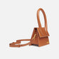 Brown handbag with a gold clasp on a white background