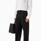 White shirt with a small black logo on the chest against a white background