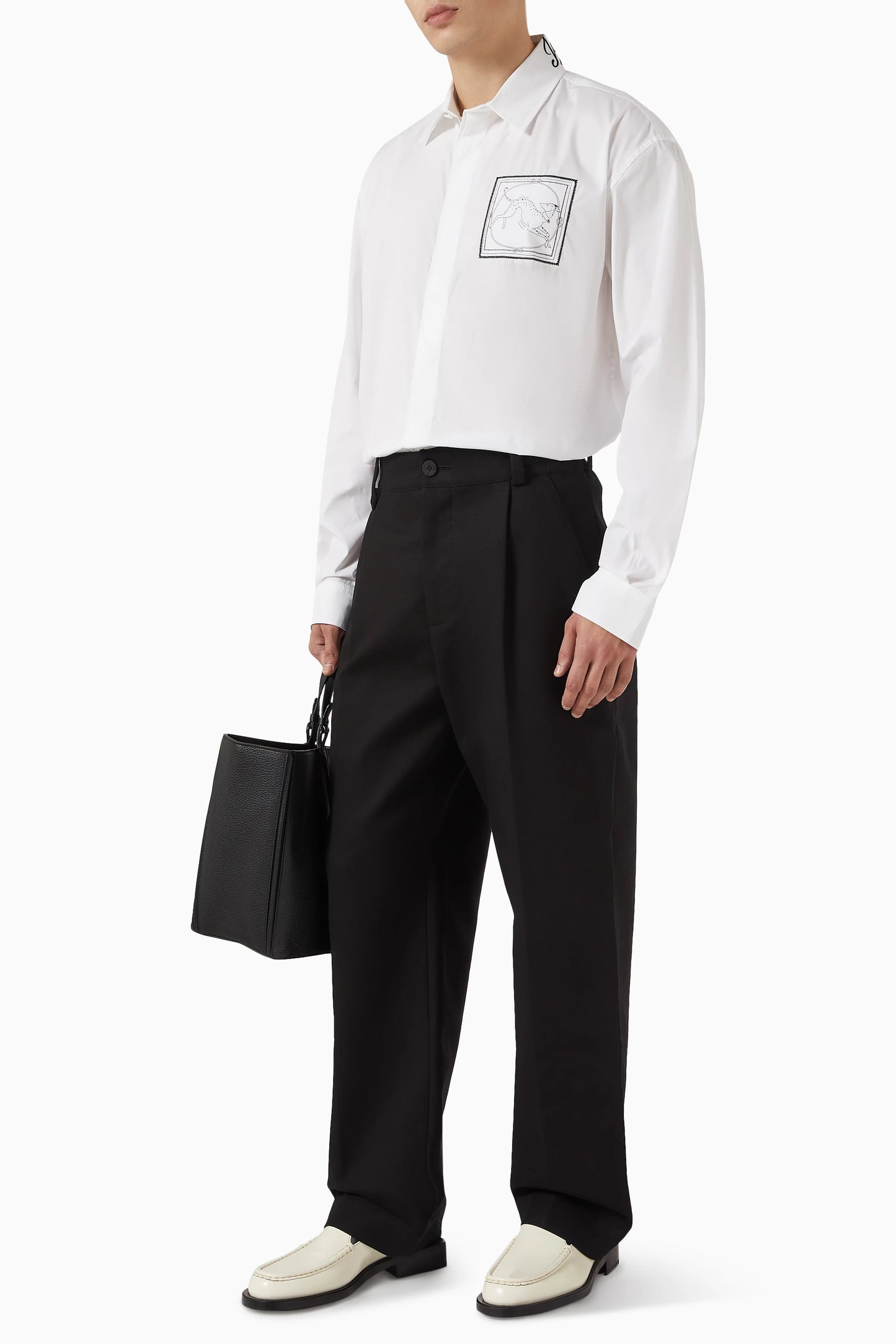 White shirt with a small black logo on the chest against a white background