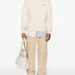 Beige hoodie with a brand logo on a white background