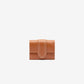 Brown leather wallet on a light beige background