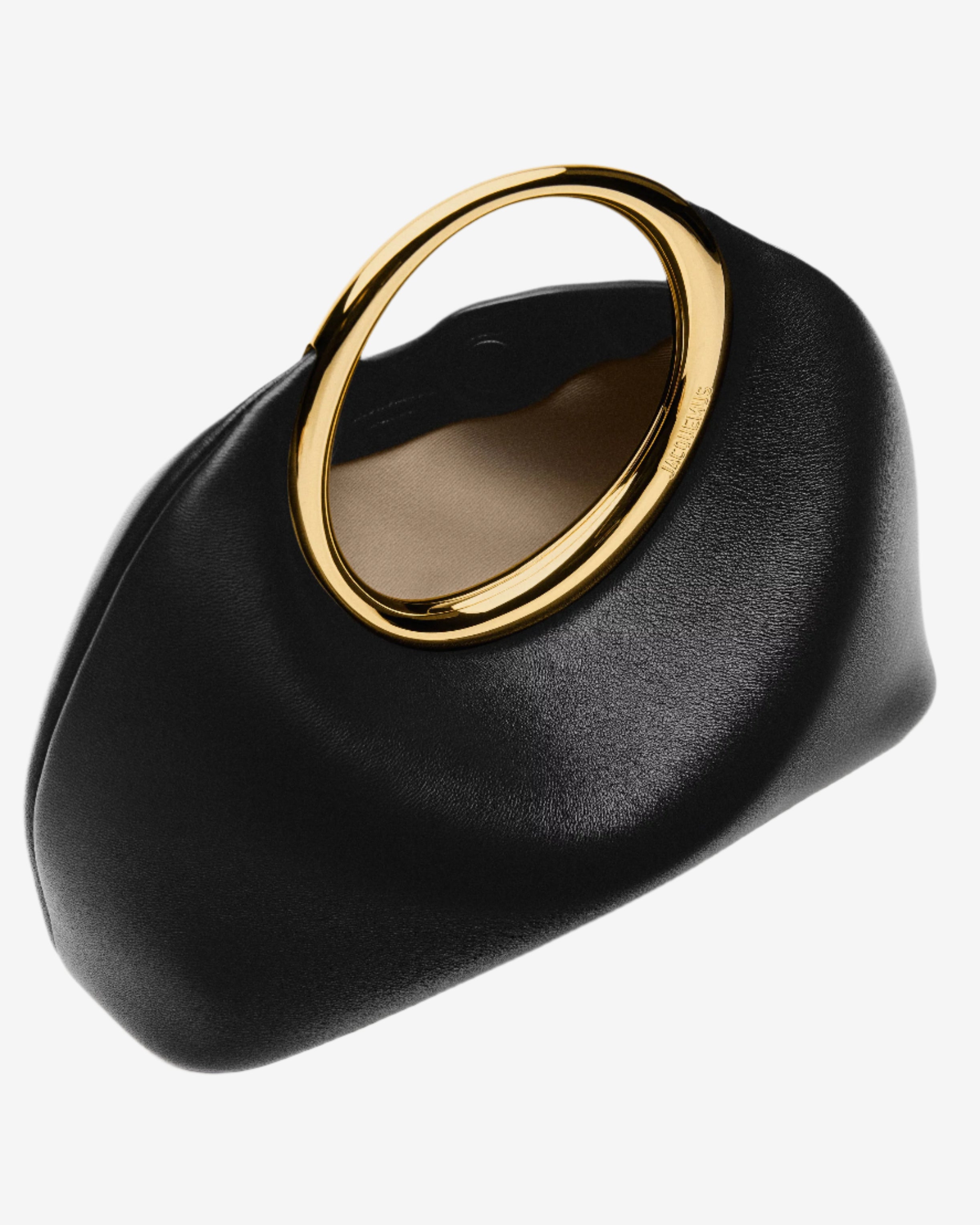 Black handbag with a gold handle on a light gray background