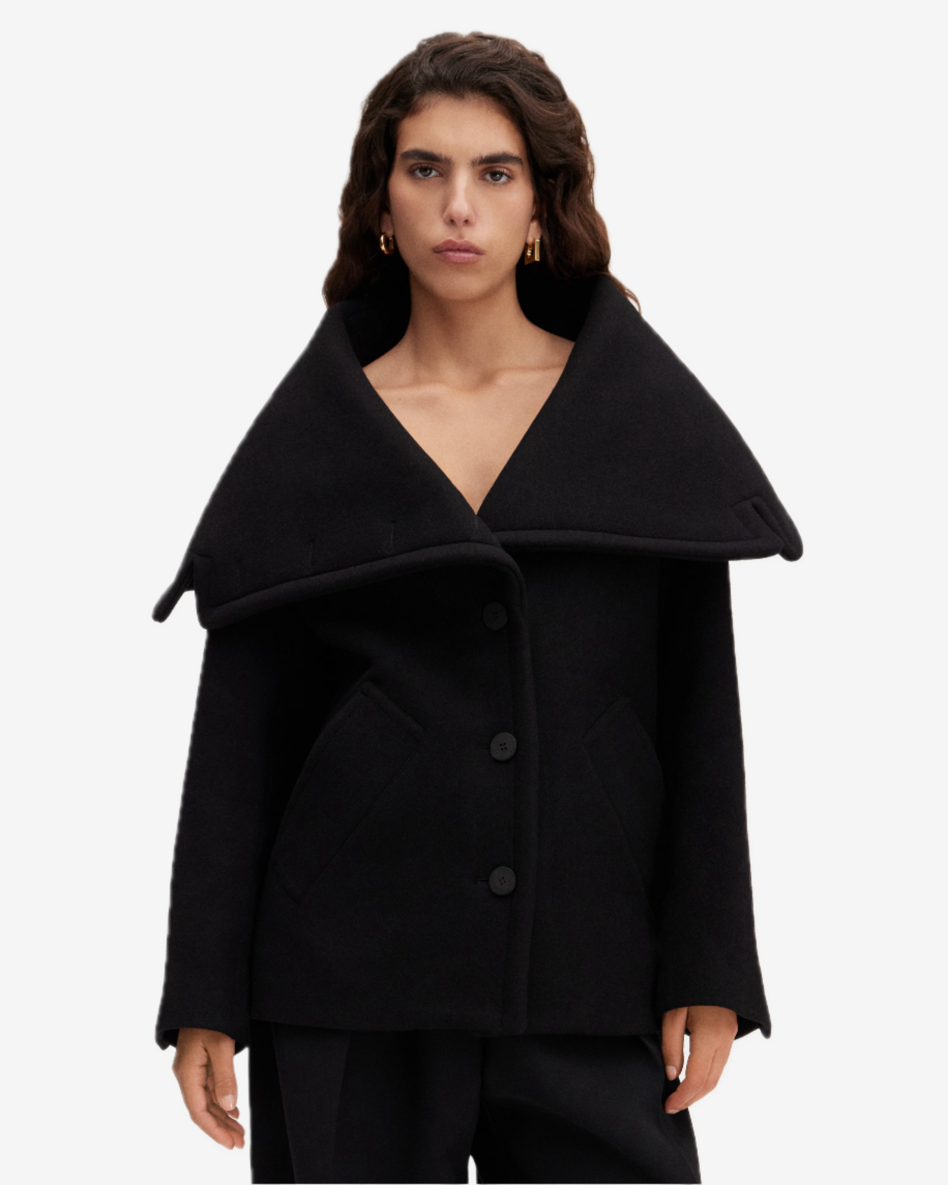 Black coat worn by a model on a white background