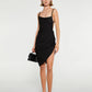 Black dress with thin straps and a draped design on a white background