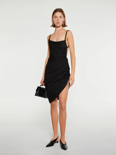 Black dress with thin straps and a draped design on a white background