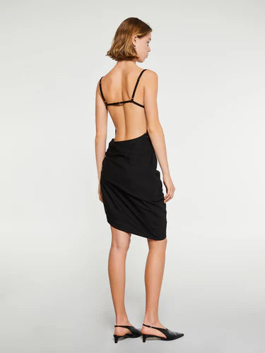 Black dress with thin straps and a draped design on a white background
