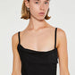 Black dress with thin straps and a draped design on a white background
