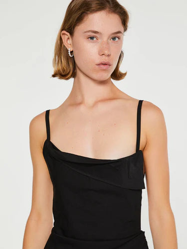 Black dress with thin straps and a draped design on a white background