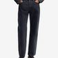 Person wearing black jeans and black shoes on a white background