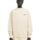 Person wearing a beige sweatshirt with a logo on a white background