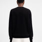 Person wearing a black sweatshirt with a logo on a white background