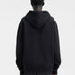 Person wearing a black hoodie with a brand logo on a white background