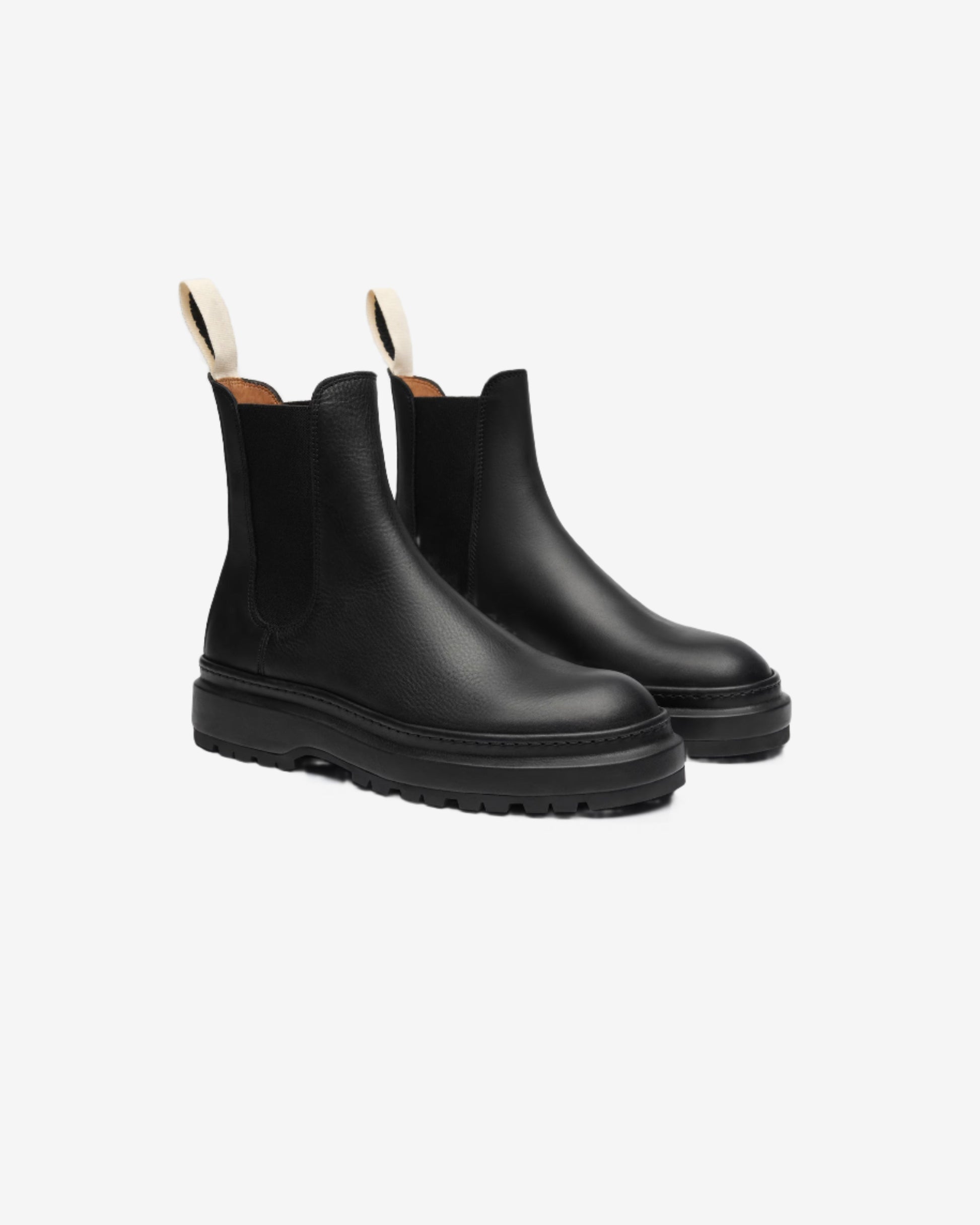 Pair of black rain boots on a light gray background