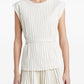 Woman wearing a white pleated dress on a white background