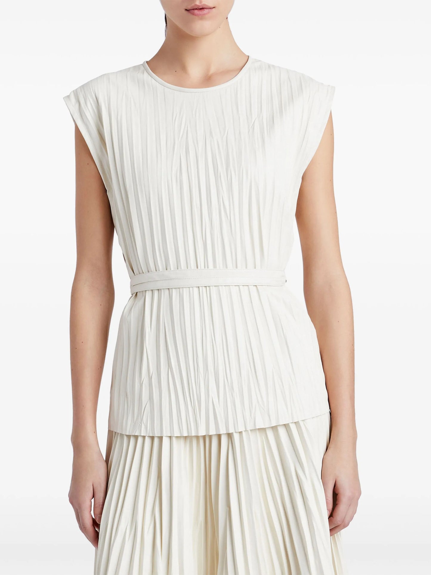 Woman wearing a white pleated dress on a white background